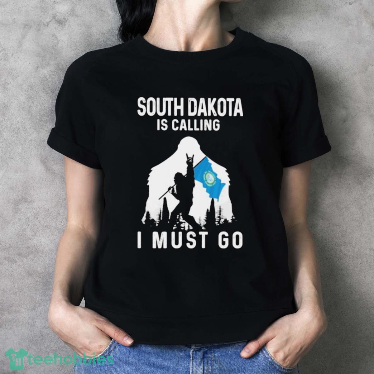 South Dakota Is Calling I Must Go Bigfoot Flag Shirt - Ladies T-Shirt